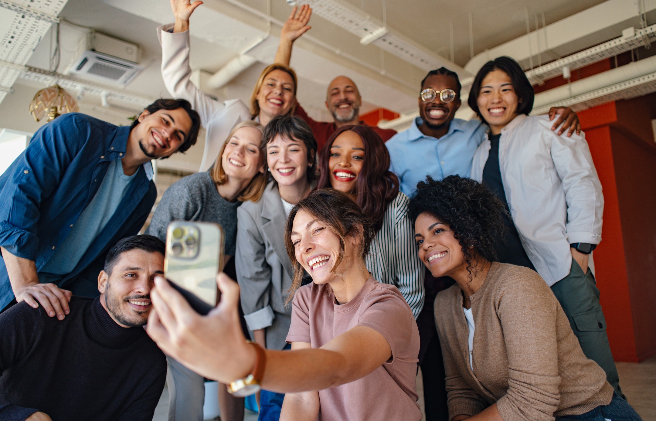 Group of colleagues greeting each other in a stylized blue duotone treatment